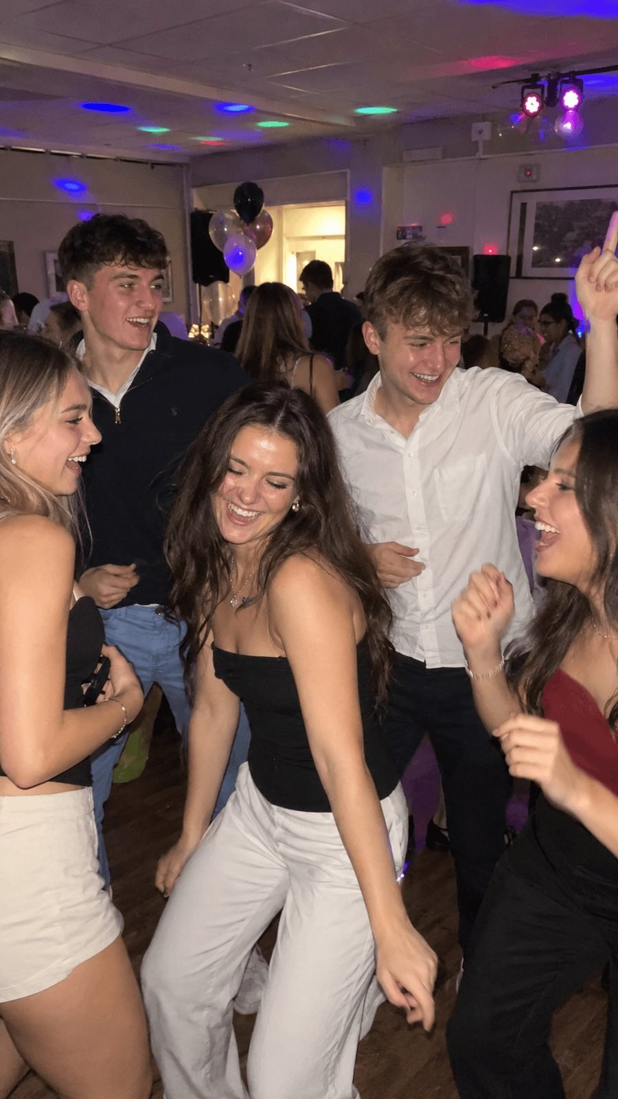 Friends laughing on the dance floor at an 18th birthday party