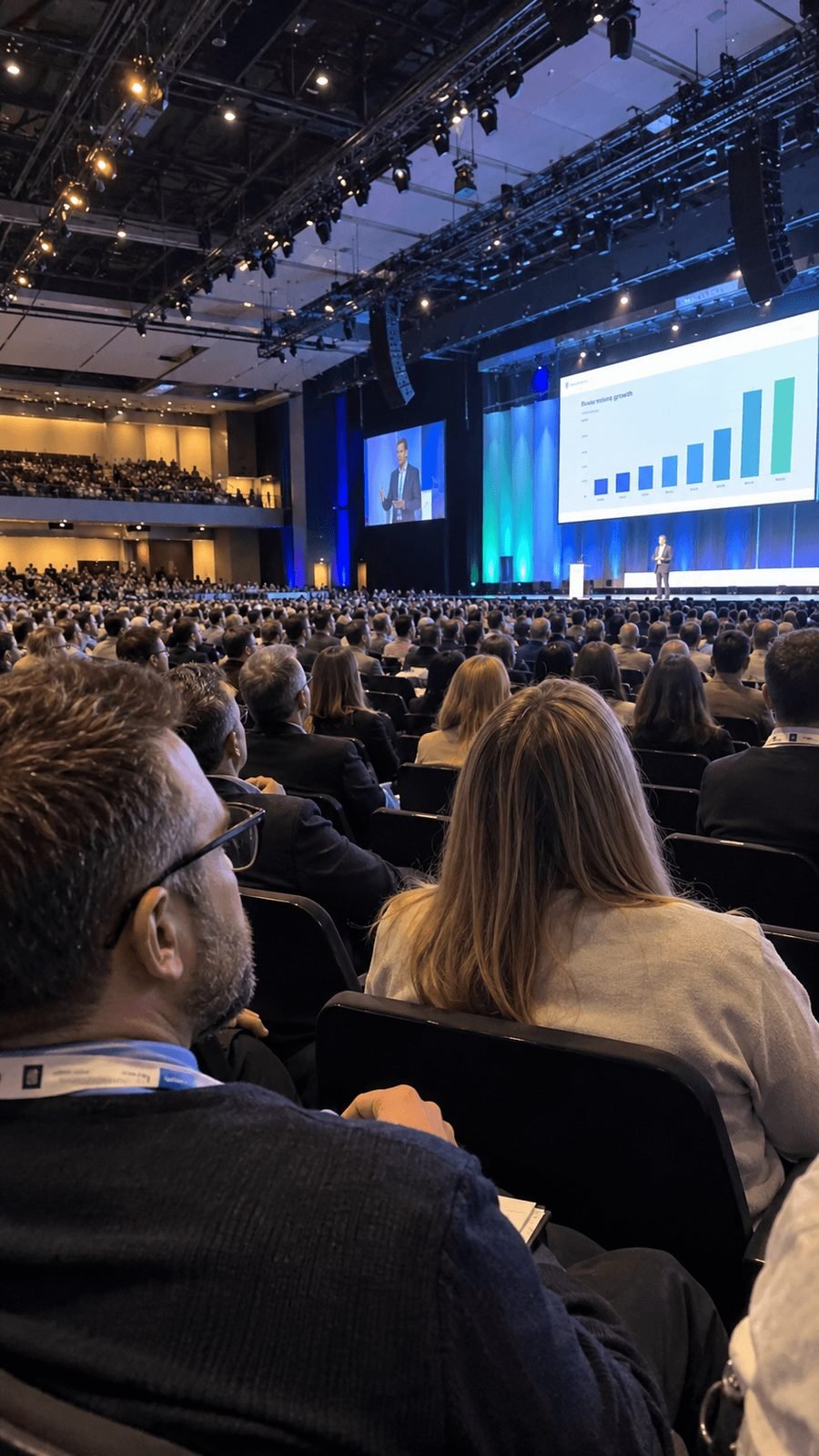 A packed conference hall, seen from a guest's seat