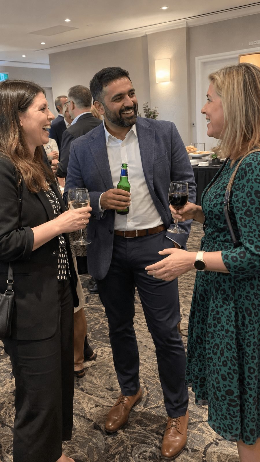 Colleagues chatting over drinks at a networking event
