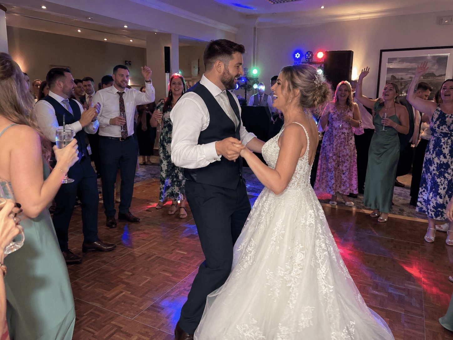 The couple dancing as their guests cheer