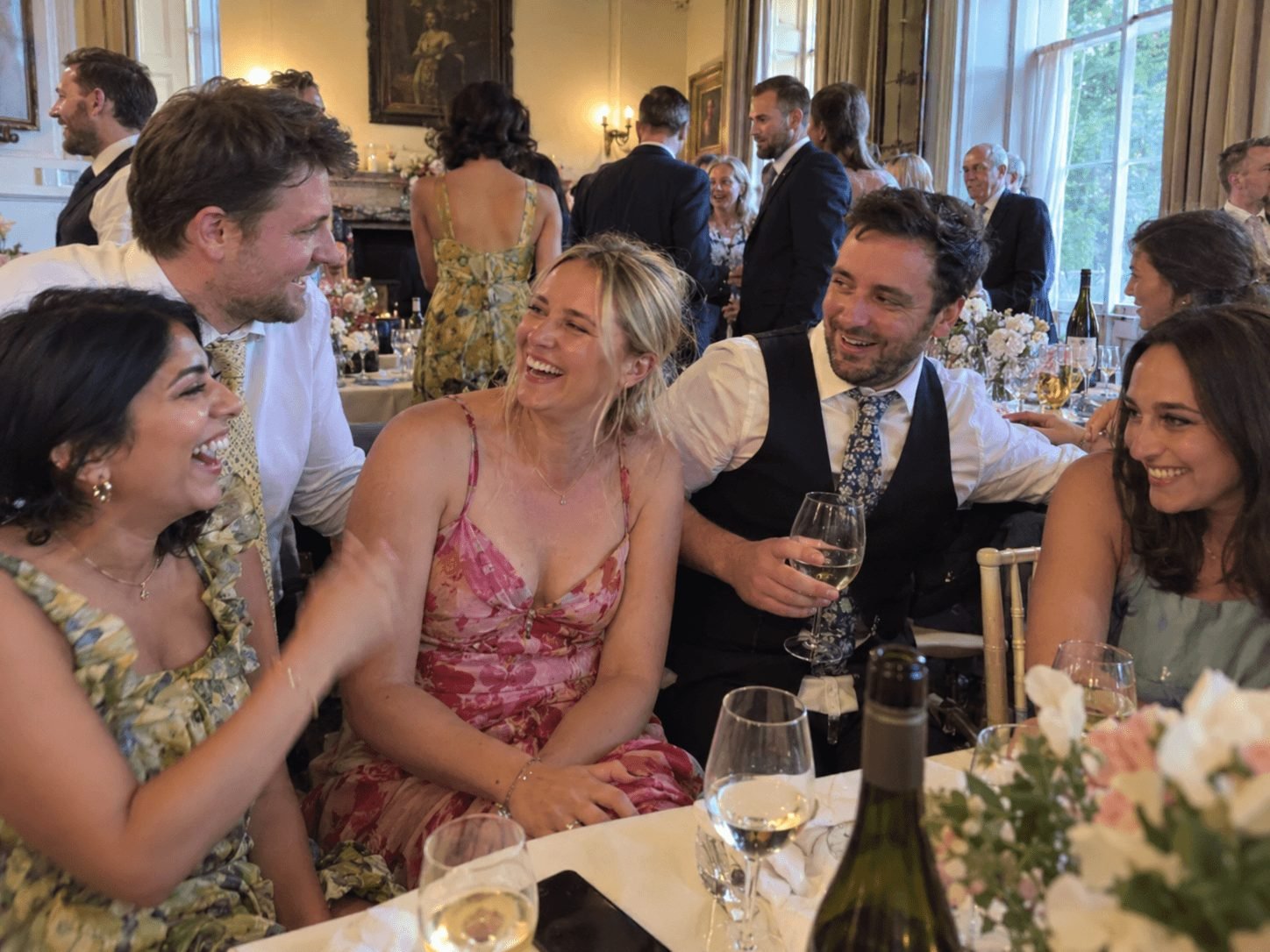 Wedding guests at a table, with phones out